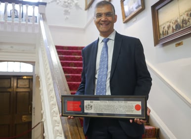 Rashik Parmar holding the Freedom of The City of London award